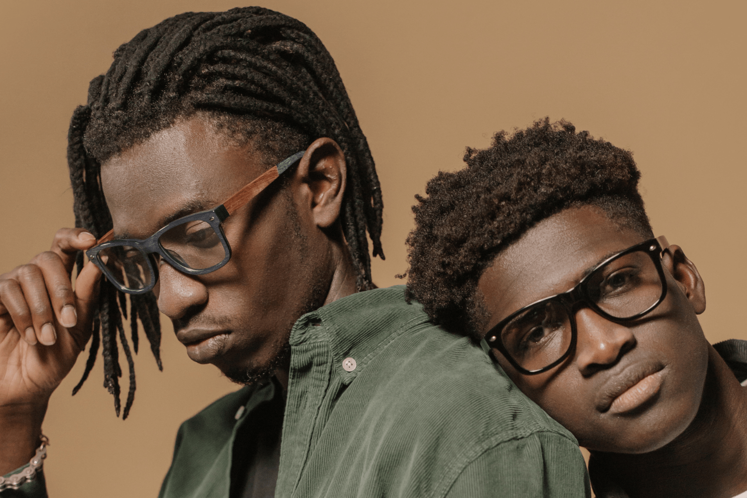 two young stylish black men wearing trendy eyeglasses